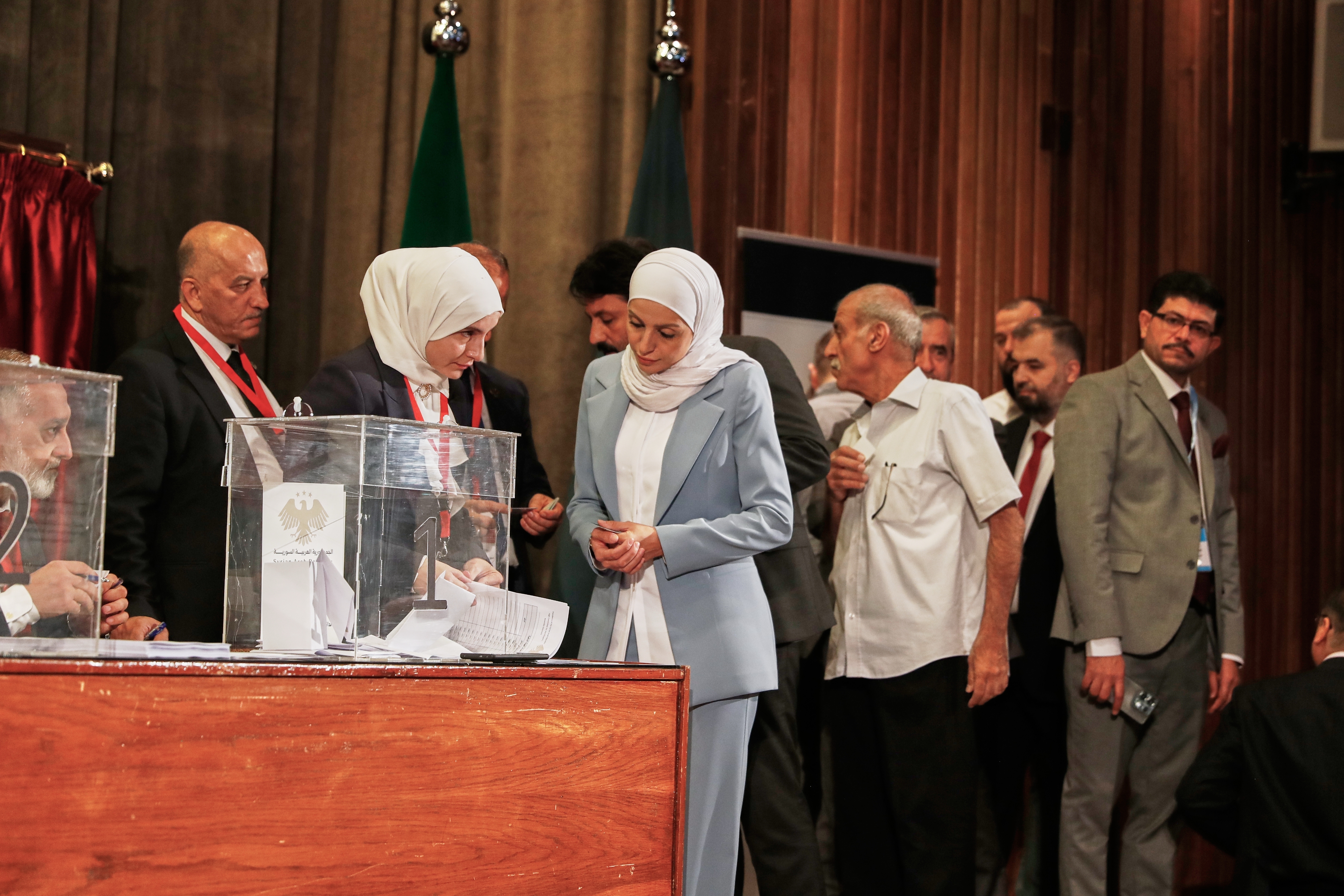 Syrian electoral college members line up to cast their ballots in a parliamentary election at a polling station in Damascus, Syria, Sunday, Oct. 5, 2025.